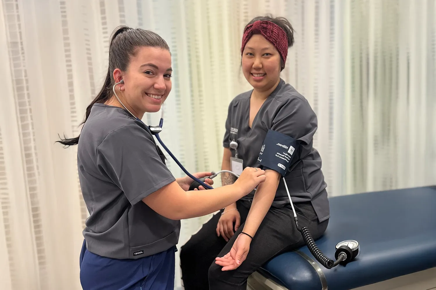 MA students checking a blood pressure